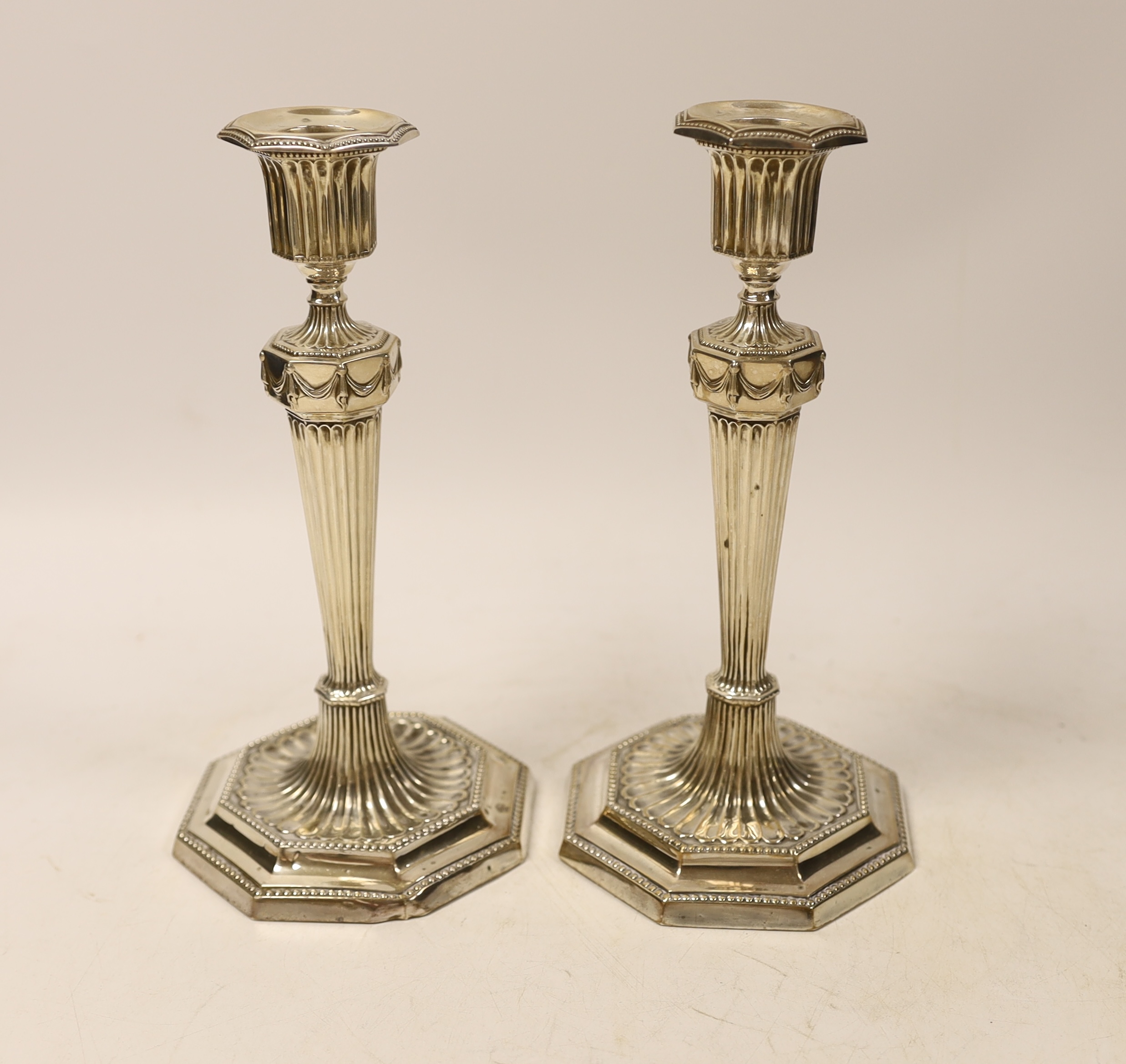 A pair of George V silver mounted candlesticks, on octagonal bases, Mappin & Webb, Sheffield, 1929, 20.9cm, weighted.